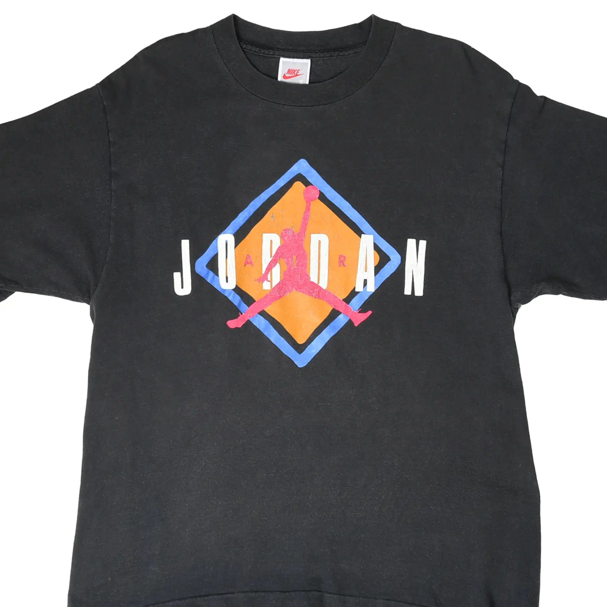 Front of black Nike T-shirt with white Jordan lettering and pink Jumpman over an orange and blue diamond