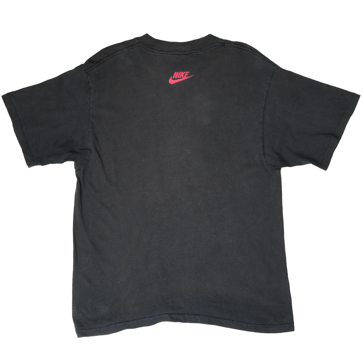 Back of black Nike T-shirt with a small pink Nike Swoosh logo below the collar