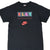 Front of black Nike P.L.A.Y. T-shirt with multicolor lettering and red Nike logo