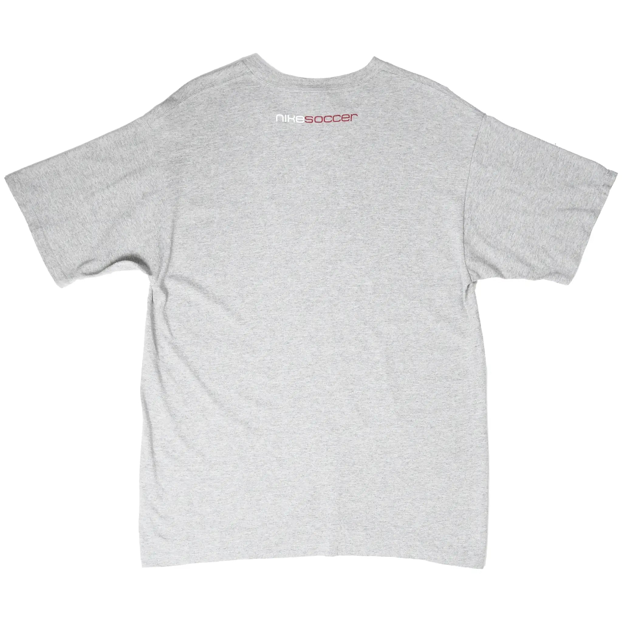 Back of grey Nike T-shirt with small white and red Nike Soccer print below collar