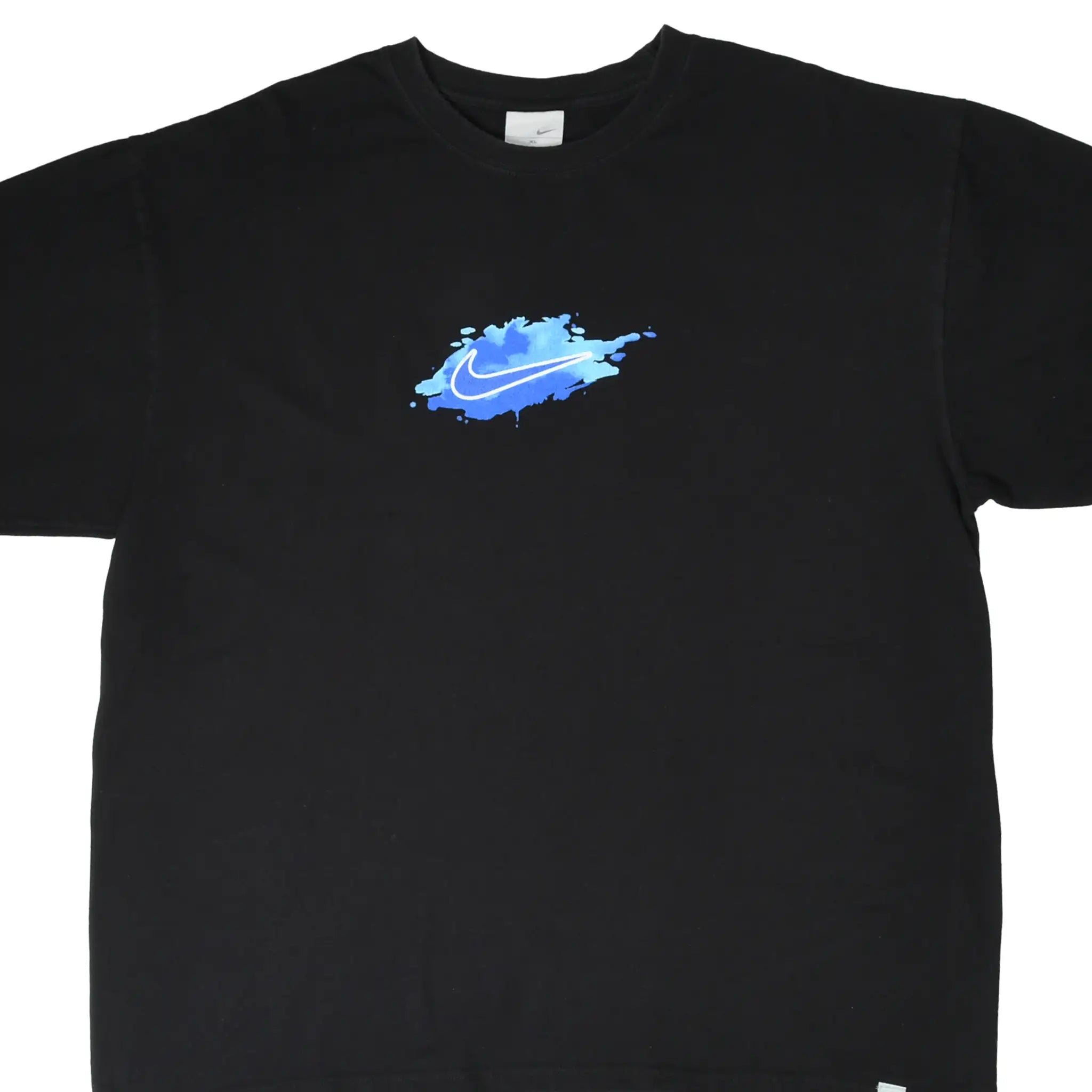 Front of black Nike T-shirt with blue paint splash and white Swoosh chest graphic