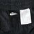 Nike waistband tag and care label showing 100% nylon and size medium