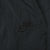 Close-up of tonal black Nike Swoosh embroidery on track pants
