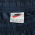 Nike waistband label with red Swoosh and size M marking