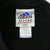 Close-up of adidas neck and care labels inside black fleece turtleneck sweatshirt