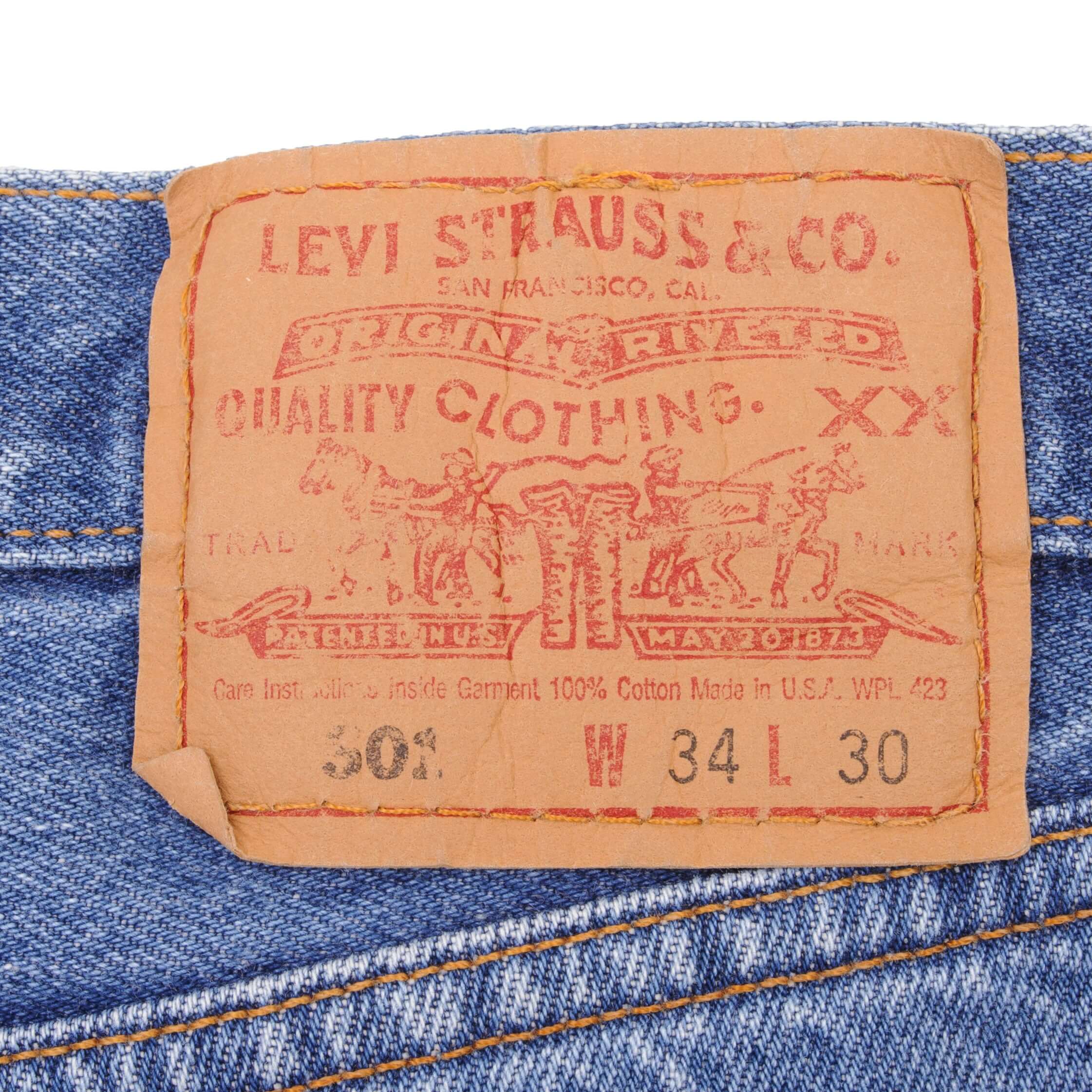 Beautiful Indigo Levis 501 Jeans 1990s Made in USA with Medium Light Wash With Light Whiskers   Size on tag 34X30   Back Button #511