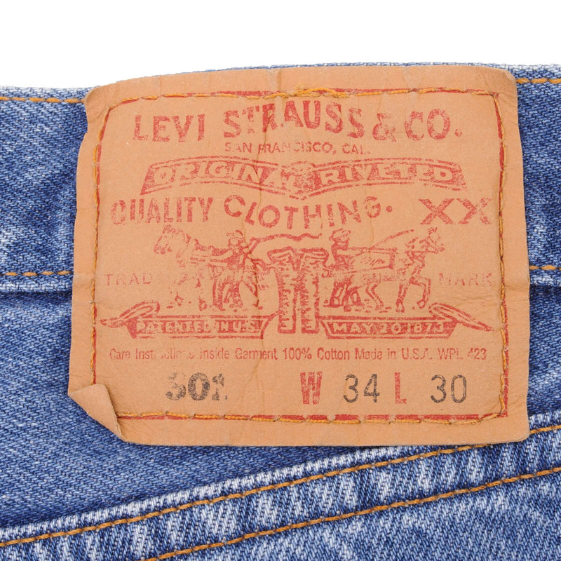 Beautiful Indigo Levis 501 Jeans 1990s Made in USA with Medium Light Wash With Light Whiskers   Size on tag 34X30   Back Button #511