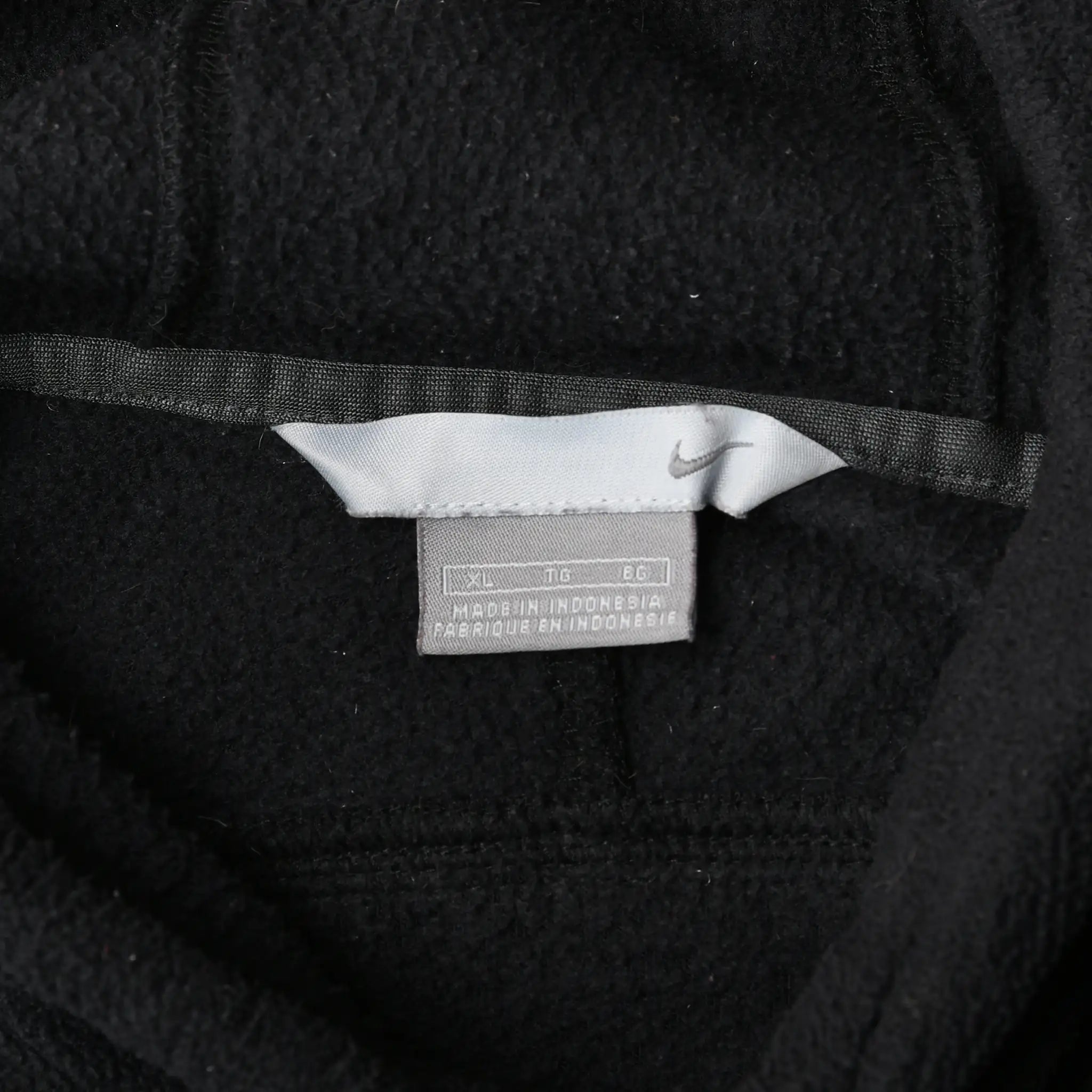 Close-up of interior Nike care label beneath white neck tag
