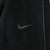 Close-up of black Nike Swoosh embroidery beside seam piping