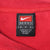 Close-up of black Nike Team medium neck label inside red sweatshirt