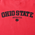 Close-up of black Ohio State Buckeyes embroidery and Nike Swoosh on red sweatshirt
