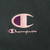 Close-up of pink and purple Champion logo embroidery on dark green fabric