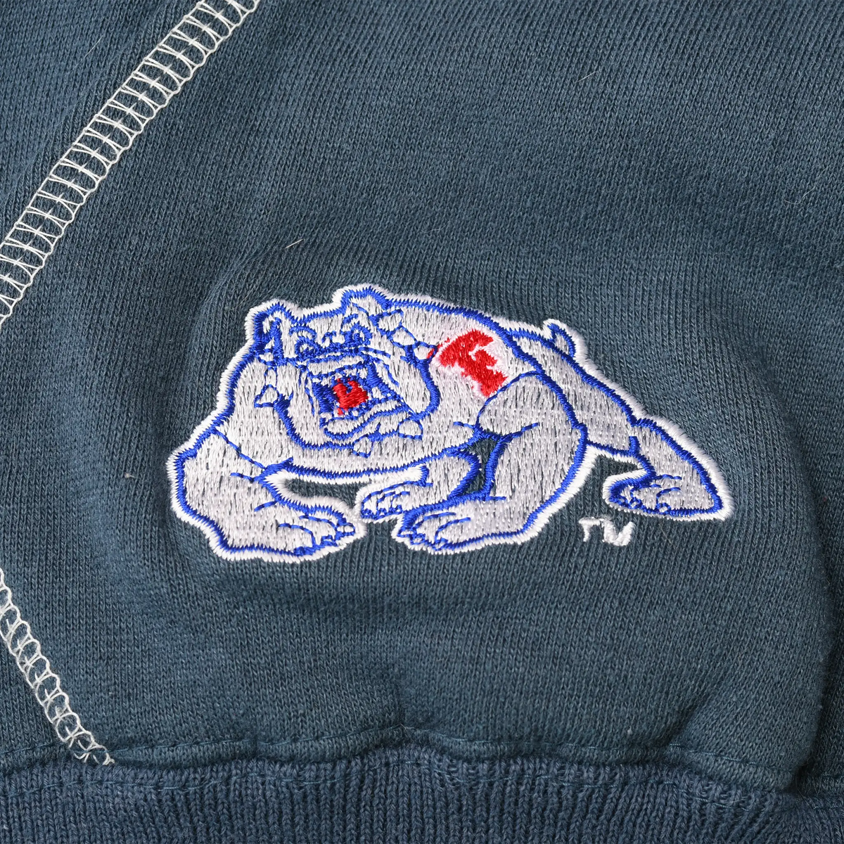 Close-up of Fresno State Bulldogs mascot embroidery on navy hoodie pocket