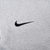 Close-up of black Nike Swoosh embroidery on grey hoodie chest