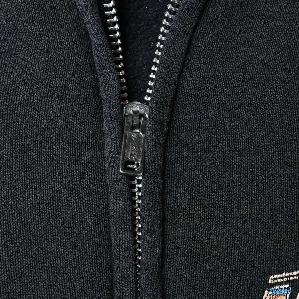 Close-up of metal front zipper and black sweatshirt fabric on Harley-Davidson hoodie