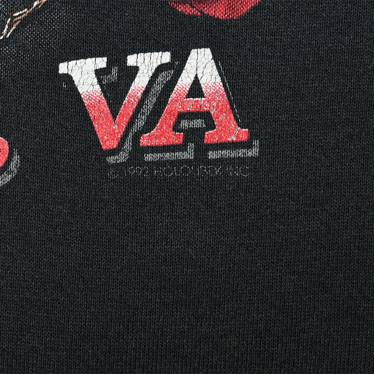 Close-up of red and white VA lettering and copyright text on black hoodie back print