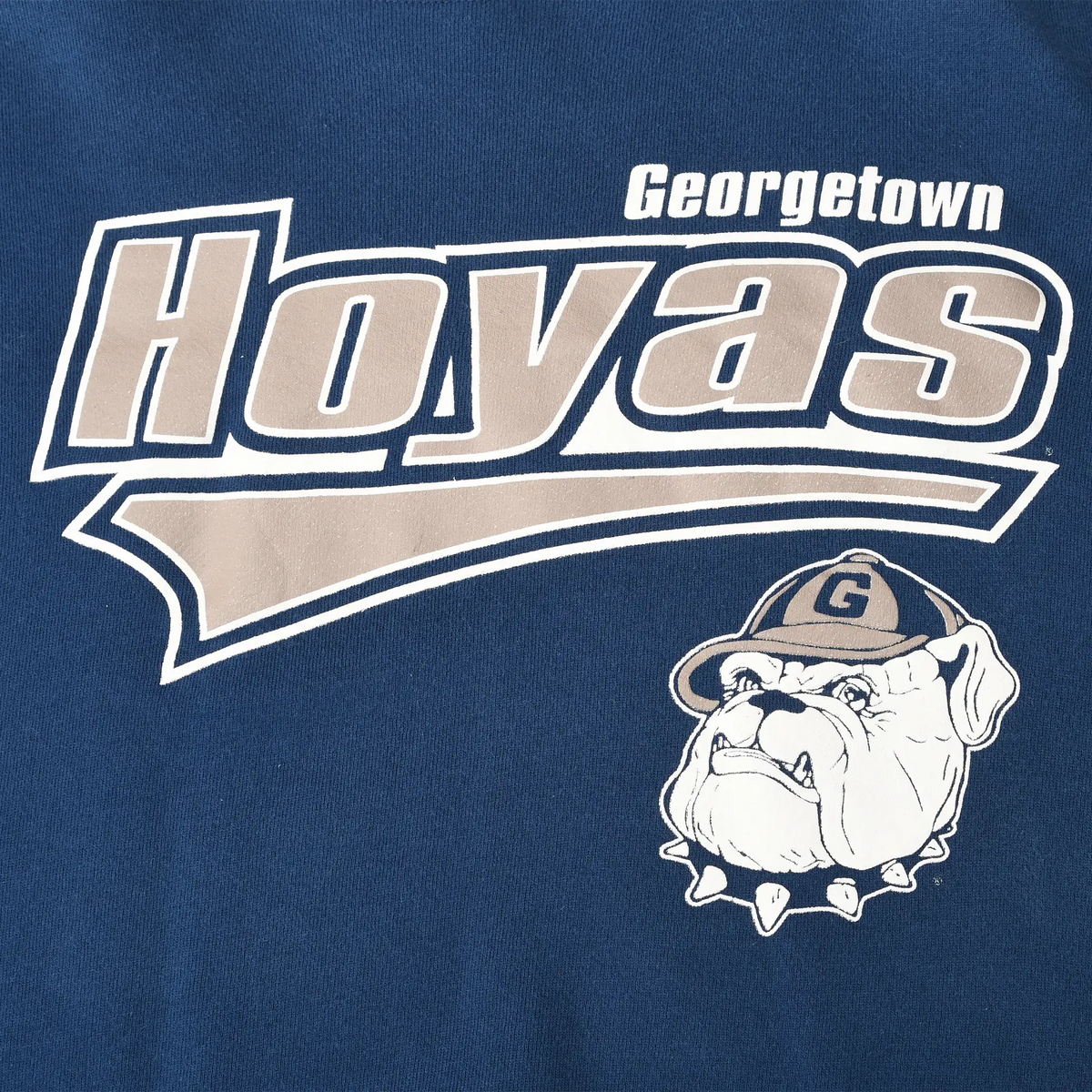 Close-up of Georgetown Hoyas chest print with gray lettering and bulldog mascot