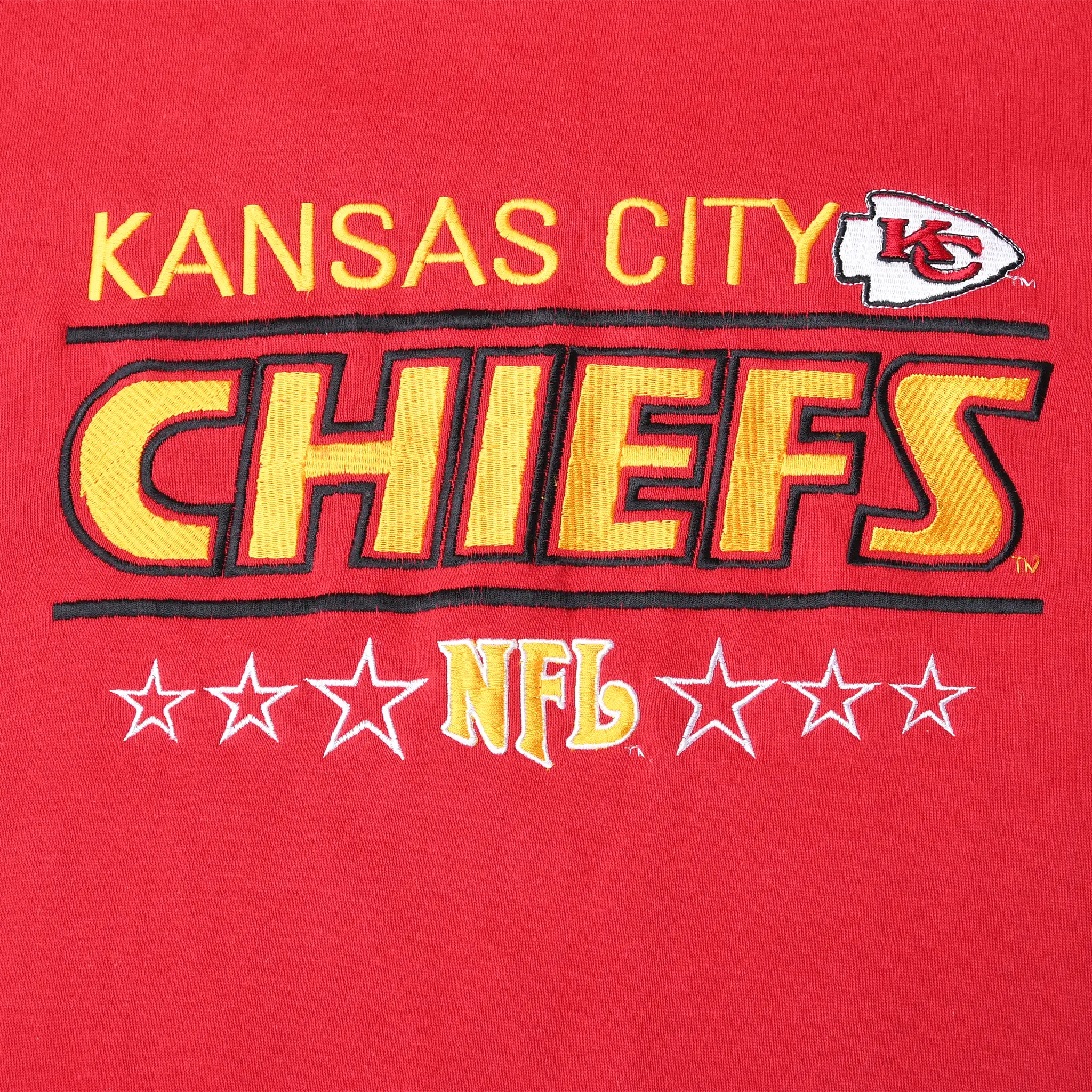 Close-up of embroidered Kansas City Chiefs and NFL graphic on red sweatshirt