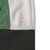 Close-up of interior white panel near dark gray hem with red arrow marking a small spot