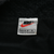 Nike L/G neck label with red Swoosh and Made in Thailand text on black mesh lining