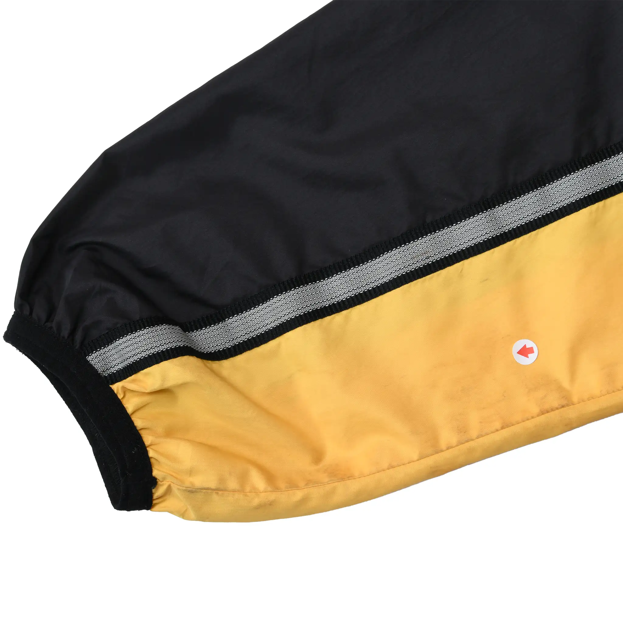 Close-up of yellow sleeve panel with gray striped trim and a marked discolored spot
