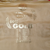 Close-up of faded gold medal history print on the jacket's gold interior lining