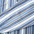 Close-up of blue, white, and tan striped sleeve fabric with a small brown spot marked by an arrow