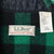 Close-up of L.L.Bean Maine Guide Shirt neck label and care tag on green and black plaid fabric