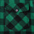 Close-up of button-flap chest pocket on green and black plaid flannel shirt