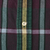 Close-up of cream button with loose thread on green, burgundy, yellow and blue plaid fabric