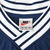 Nike neck label and white striped V-neck trim on navy pullover windbreaker