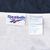 Reebok neck and care labels inside windbreaker jacket showing size XL