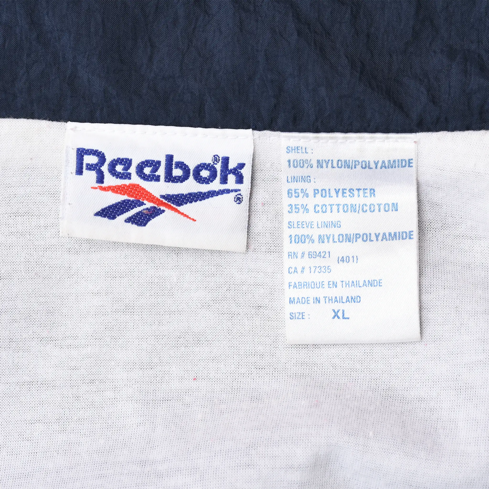 Reebok neck and care labels inside windbreaker jacket showing size XL