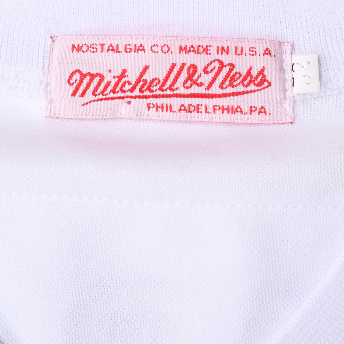 Mitchell & Ness Nostalgia Co. Made in USA neck label on white jersey