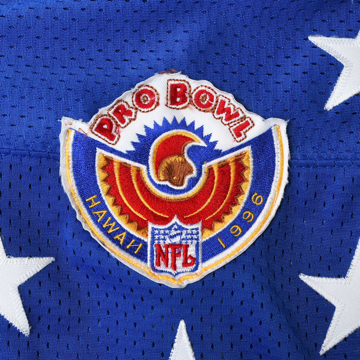 Close-up of embroidered Pro Bowl Hawaii 1996 NFL crest on blue mesh fabric