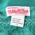 Mitchell & Ness collar label and size 56 care tag on aqua mesh jersey fabric