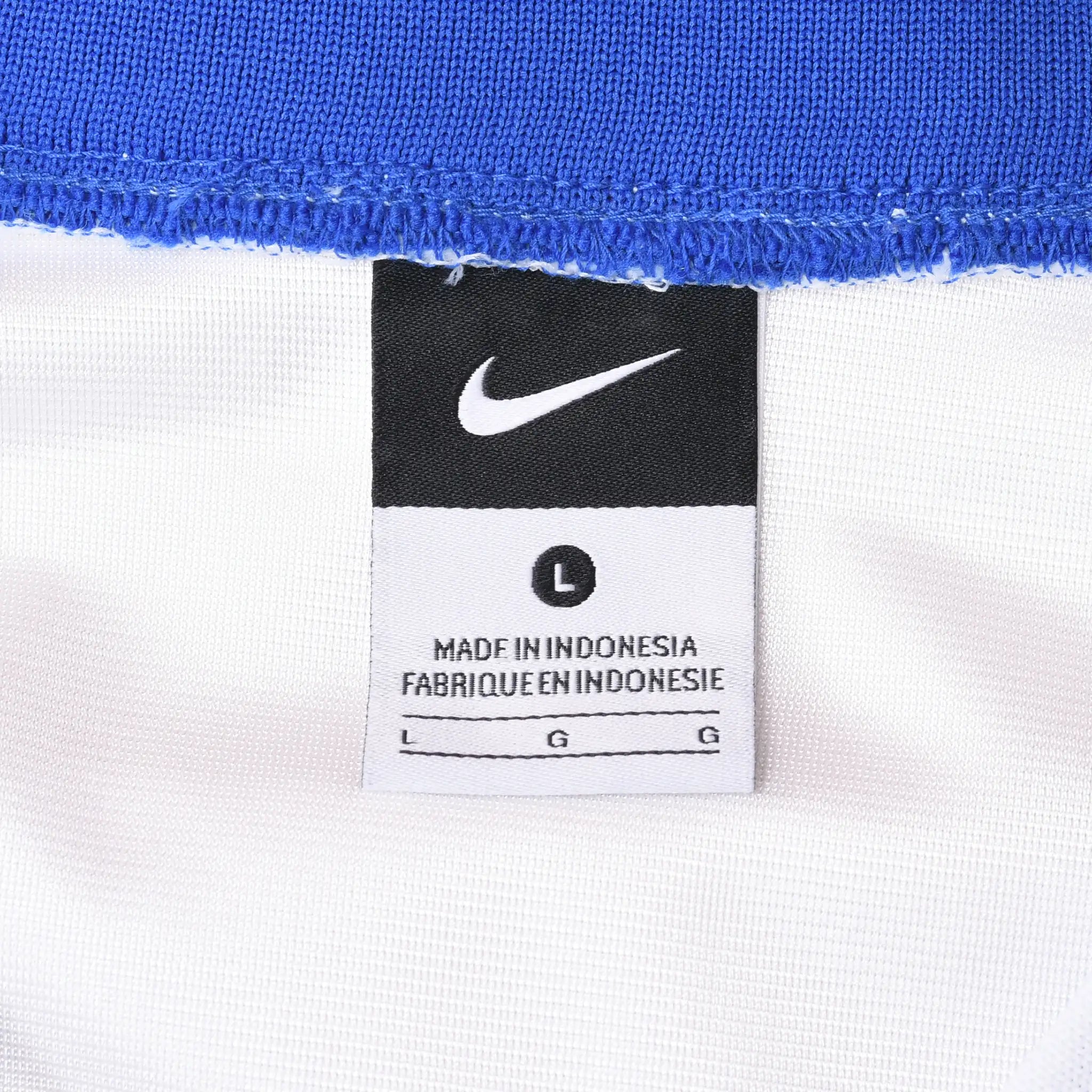 Close-up of black Nike neck label marked size large inside the white jersey