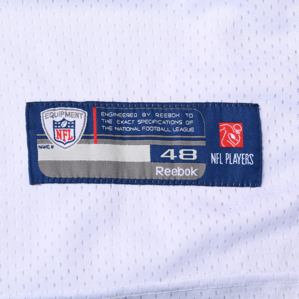 Close-up of Reebok NFL Players size 48 jock tag on white mesh jersey