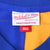 Mitchell & Ness Legacy Collection neck label on blue and gold jersey