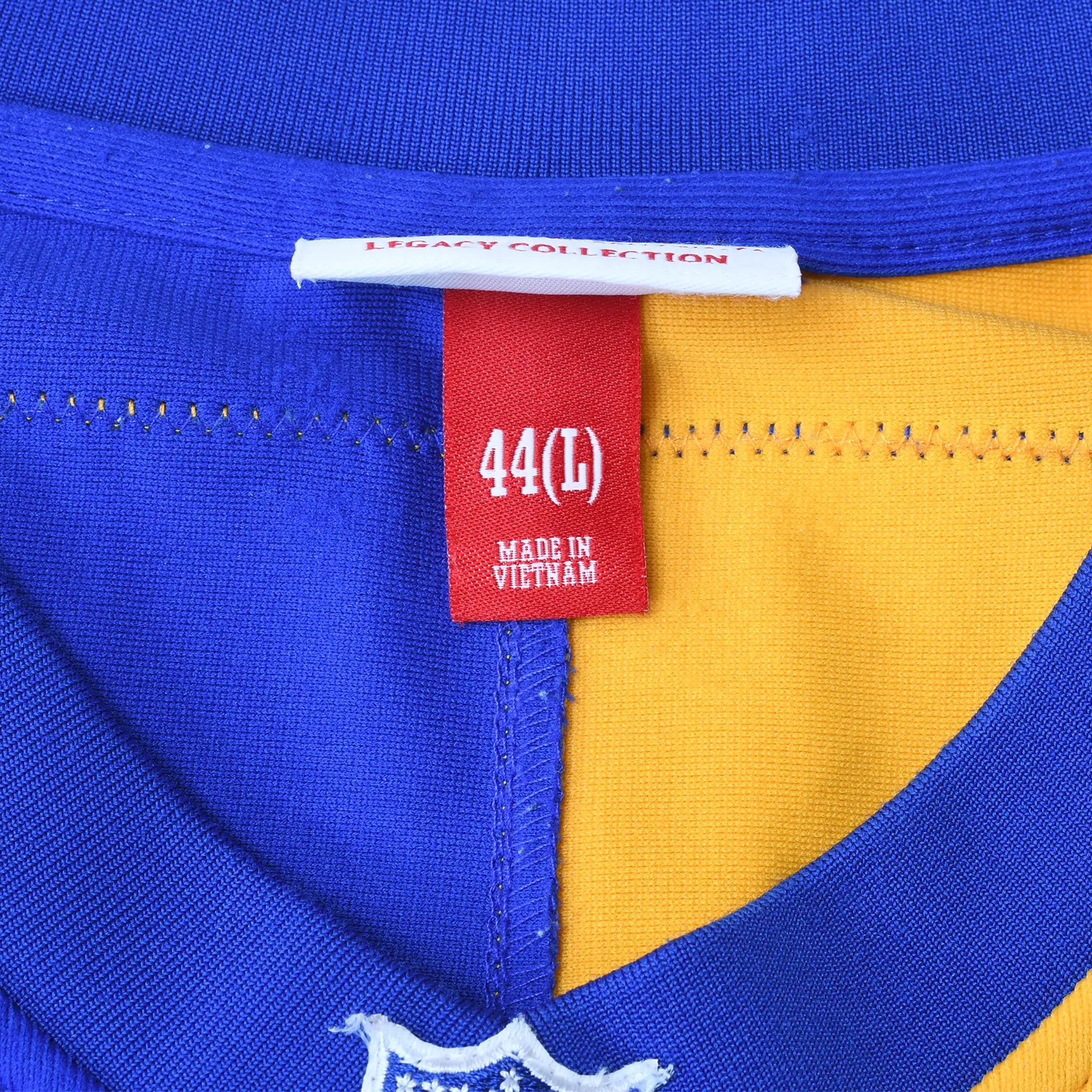 Jersey neck size tag marked 44 (L) above embroidered NFL shield