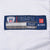 Close-up of Reebok NFL Equipment size 52 jock tag on white jersey fabric