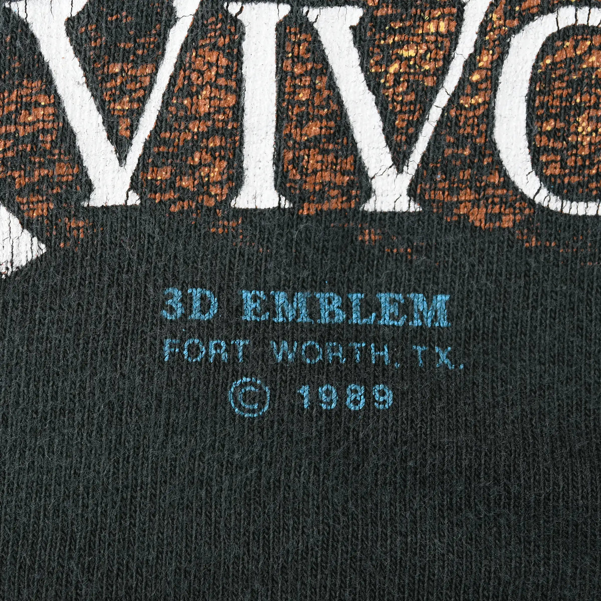 Close-up of blue 3D Emblem Fort Worth, Texas, copyright 1989 print beneath front graphic