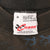 Close-up of Chase Authentics XL neck label stating 100% cotton and made in the USA