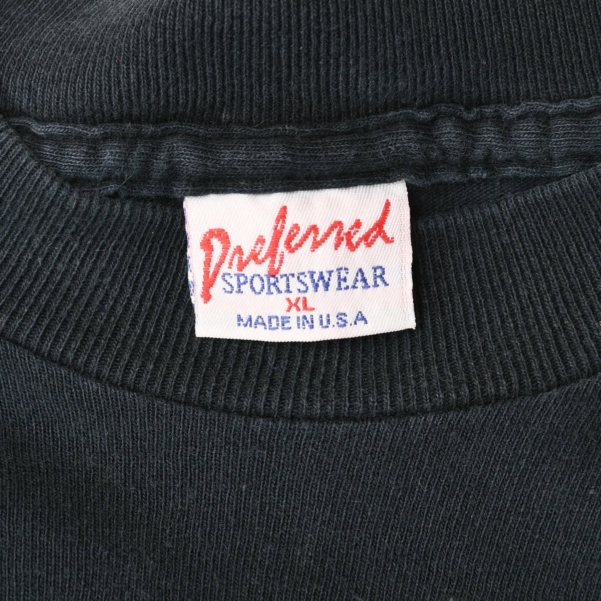 Neck tag close-up reading Weekend Sportswear, XL, Made in U.S.A.