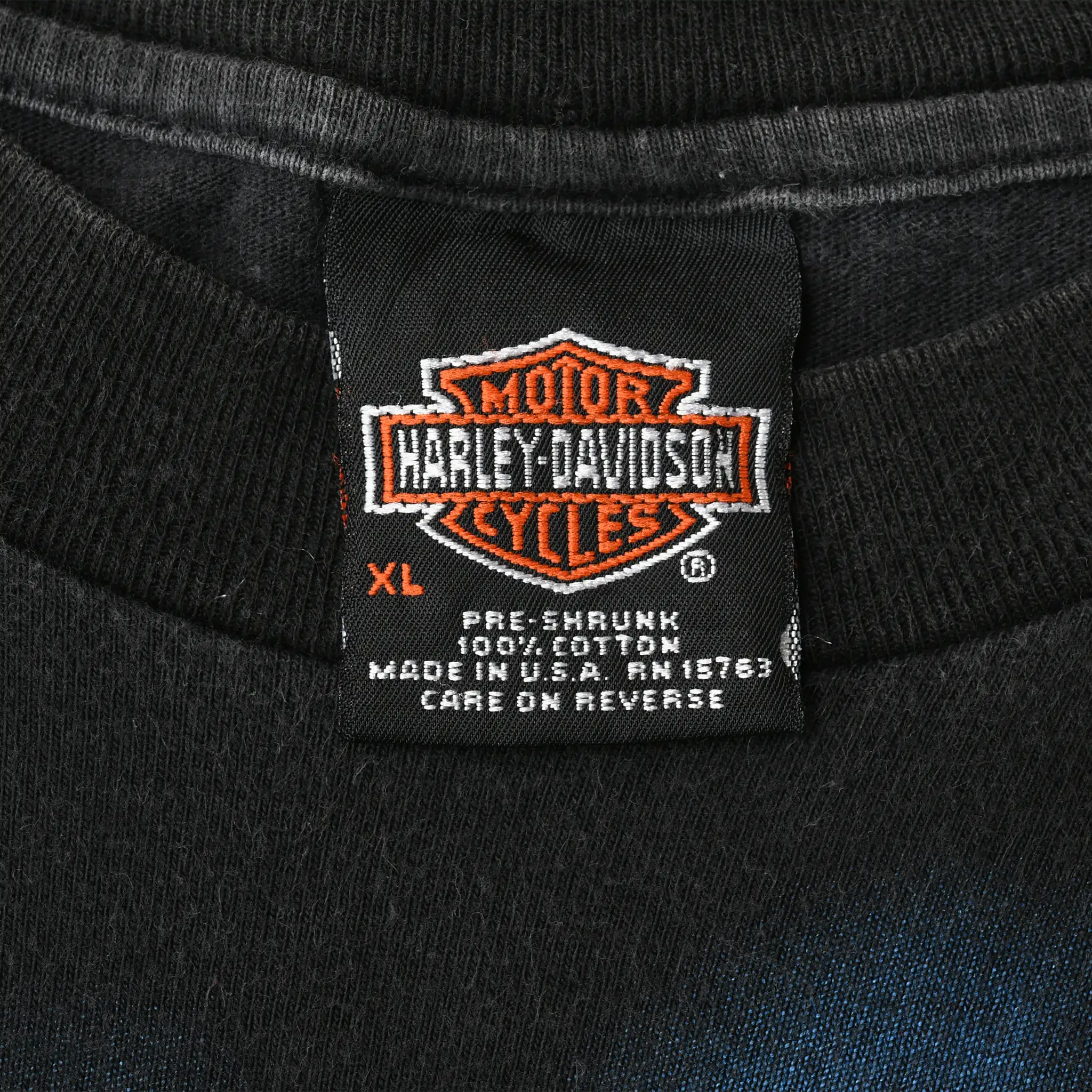 Harley-Davidson neck tag showing size XL, 100% cotton, and Made in USA