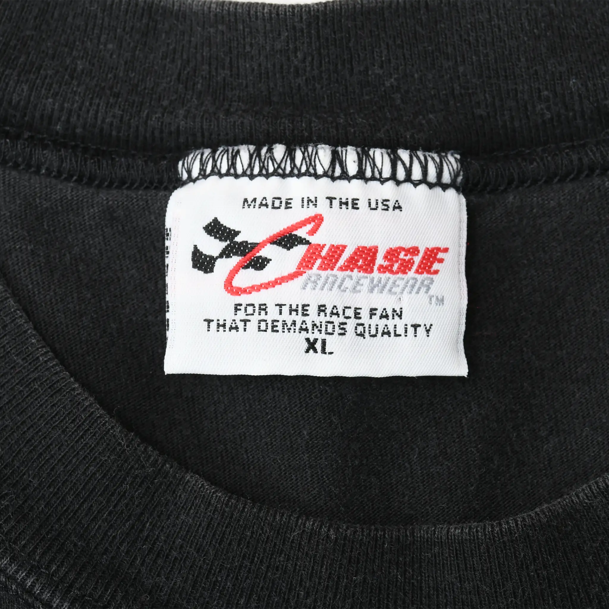Close-up of Chase Authentics XL neck label marked Made in the USA inside black tee