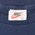 Close-up of Nike neck label marked XL inside blue T-shirt collar