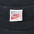 Close-up of Nike XXL Made in U.S.A. neck tag on black T-shirt