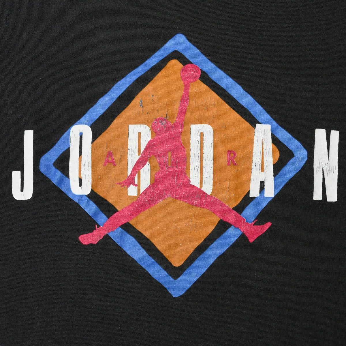 Close-up of Jordan print with white lettering, pink Jumpman, and orange and blue diamond