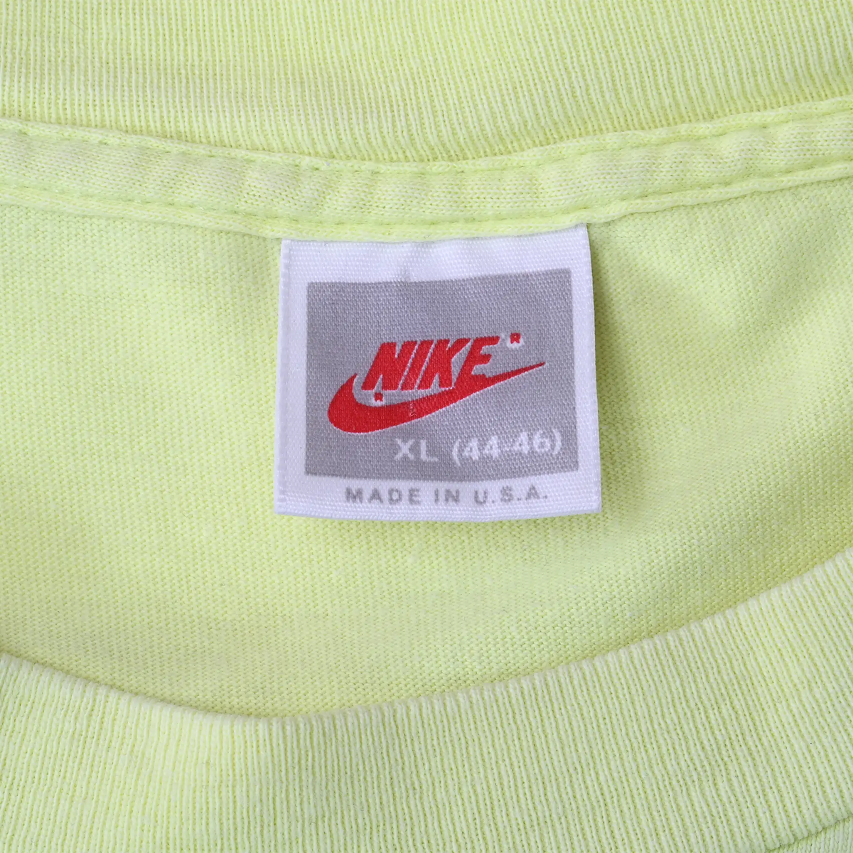 Close-up of Nike neck tag marked XL (44-46) and Made in U.S.A.